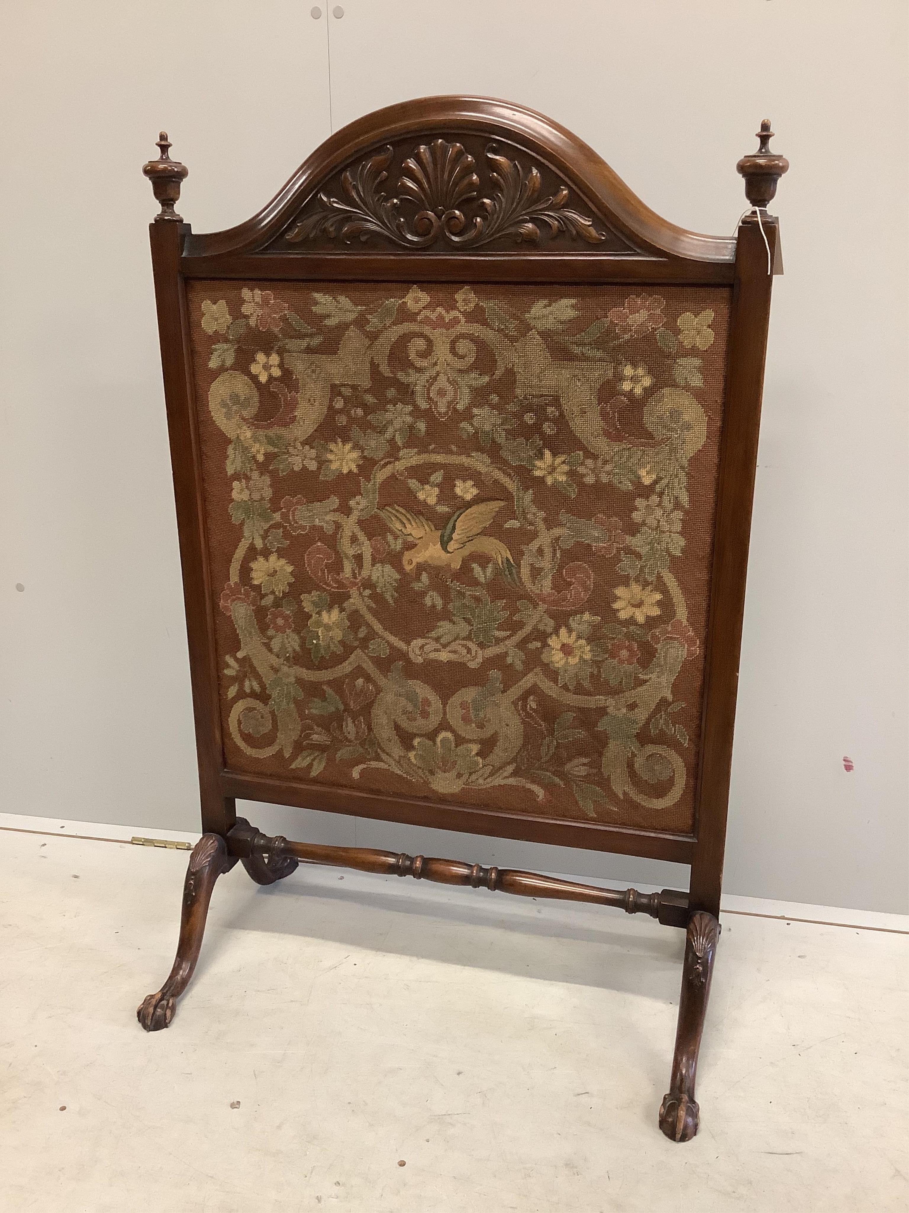 An early 20th century carved mahogany fire screen with tapestry panel, width 76cm, height 120cm. Condition fair to good.